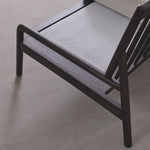 Modern lounge chair with beige cushion on a light gray background