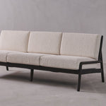 Beige sofa with black frame on a gray background