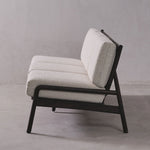 Gray upholstered chair with black frame on a gray background