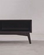 Dark wooden TV stand against a plain wall