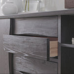 Wooden cabinet with drawers and decorative items on a light gray background