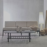 Modern living room with a beige sofa, coffee table, and decorative items.