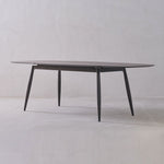 Round glass table with metal legs on a white background