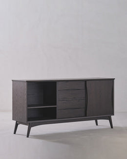 Dark wooden sideboard with open shelves and closed doors on a light gray background