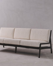 Beige sofa with black frame on a gray background