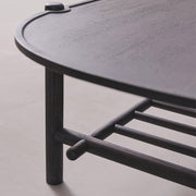 Black metal shelf with curved design on a light gray background