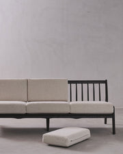 Sofa with ottoman on a plain background