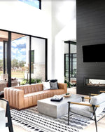 Modern living room with a brown sofa, coffee table, and wall-mounted TV.