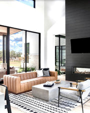 Modern living room with a brown sofa, coffee table, and wall-mounted TV.