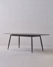 Round glass table with metal legs on a white background