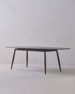 Round glass table with metal legs on a white background