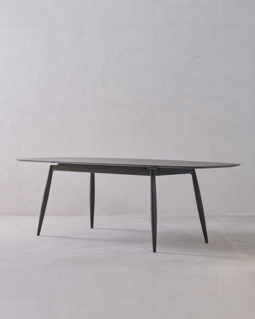 Round glass table with metal legs on a white background