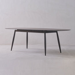 Round glass table with metal legs on a white background