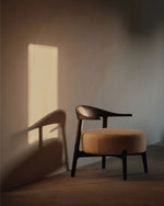 Wooden chair with a cushioned seat in a softly lit room