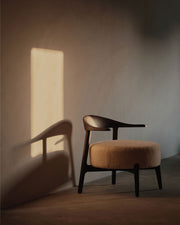 Wooden chair with a cushioned seat in a softly lit room