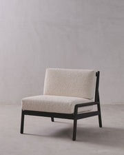 Modern chair with beige cushion on a plain background