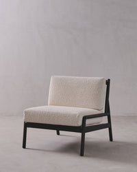 Modern chair with beige cushion on a plain background