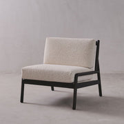 Modern chair with beige cushion on a plain background